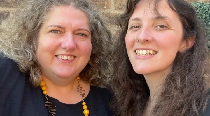 Two women smile at the camera