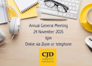 Image shows a desk with headphones, keyboard, glasses, a cup of tea and notebooks and includes the detail that the CJD Support Network will be held on 24 Nomveber 2025 at 6pm via Zoom or Telephone.
